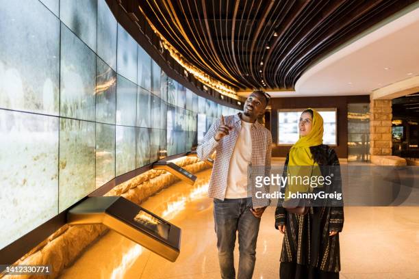 tourists viewing saudi history in at-turaif visitor’s centre - old saudi man stock pictures, royalty-free photos & images