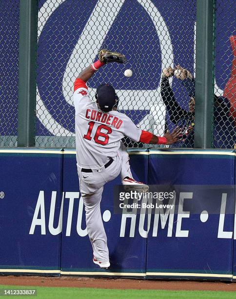 Franchy Cordero of the Boston Red Sox comes up short on a ball at the wall off the bat of Yuli Gurriel of the Houston Astros that went for a double...