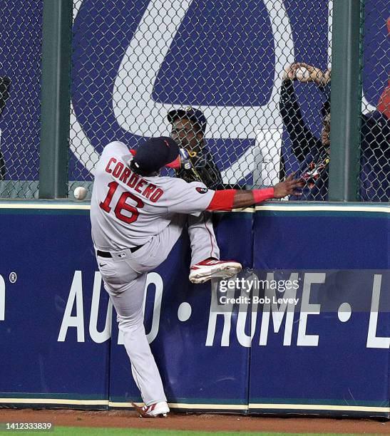 Franchy Cordero of the Boston Red Sox comes up short on a ball at the wall off the bat of Yuli Gurriel of the Houston Astros that went for a double...