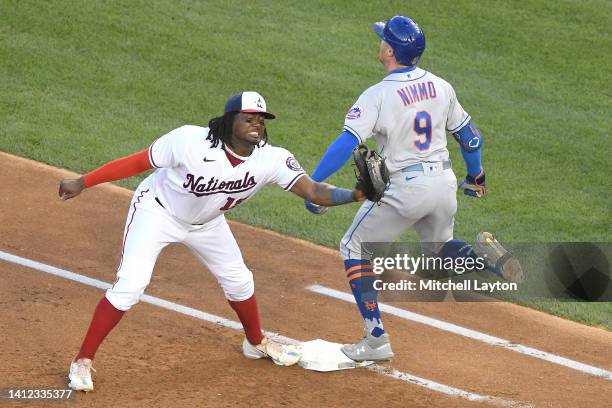 Brandon Nimmo of the New York Mets beats the throw to Josh Bell of the Washington Nationals for an infield single in the second inning at Nationals...