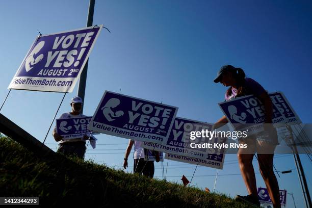 Olathe, KANSAS Supporters of the Vote Yes to a Constitutional Amendment on Abortion remove signs along 135th Street on August 01, 2022 in Olathe,...