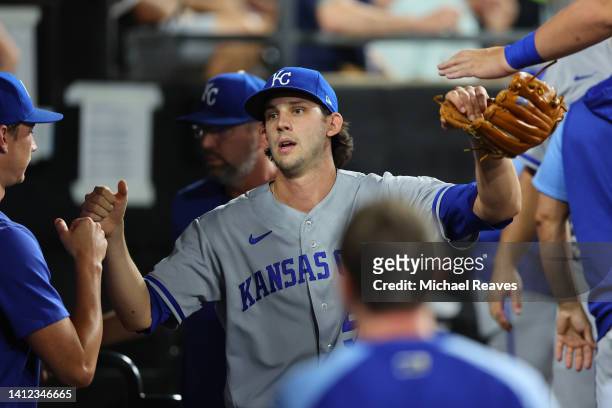 Daniel Lynch of the Kansas City Royals high fives teammates after being removed from the game during the sixth inning against the Chicago White Sox...