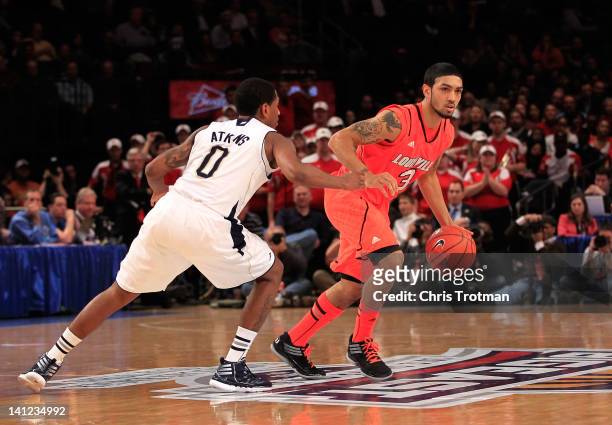 Peyton Siva of the Louisville Cardinals handles the ball against Eric Atkins of the Notre Dame Fighting Irish during the semifinals of the Big East...