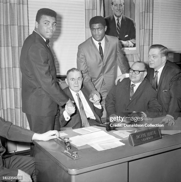 Heavyweight Champion Muhammad Ali and WBA heavyweight champion Ernie Terrell sign the contract to fight on March 29th 1966 at the International...