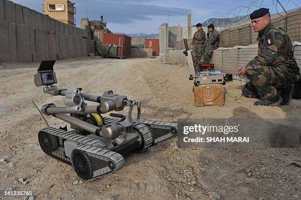French soldier maneuvers a remotely-controlled IED detecting robot during a training exercise at a combat outpost base in Usbeen village in Surobi...