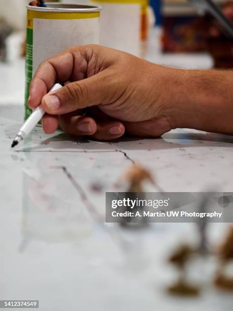 role-playing figures on a whiteboard and an adult's hand drawing the dungeon during a role-playing game. - d20 stock pictures, royalty-free photos & images