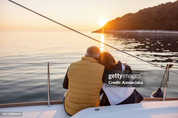 lovely mature couple hugging on a yacht - air date stock pictures, royalty-free photos & images