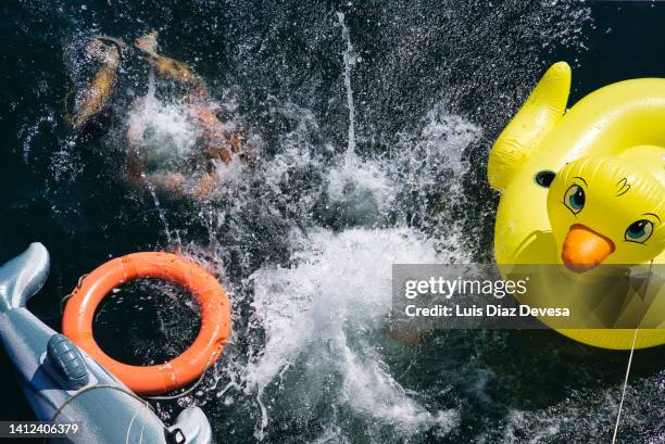 man jumping into ocean - boat party stock pictures, royalty-free photos & images