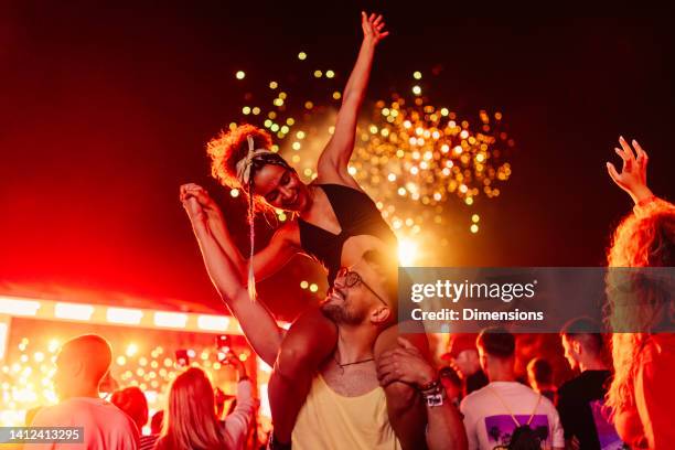 couple celebrating with fireworks - woman at festival stock pictures, royalty-free photos & images