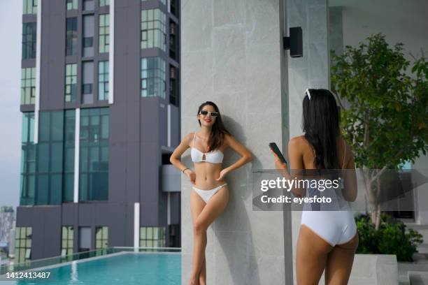 pretty women are wearing swimsuit and do activity at swimming pool. - center for asian american media stock pictures, royalty-free photos & images