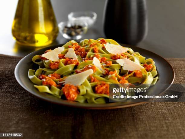 tagliatelle verdi pasta with calabrese pesto and parmesan cheese shavings - shaved parmesan cheese stock pictures, royalty-free photos & images
