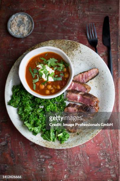 sliced steak chickpeas in sauce kale - steak rind bildbanksfoton och bilder