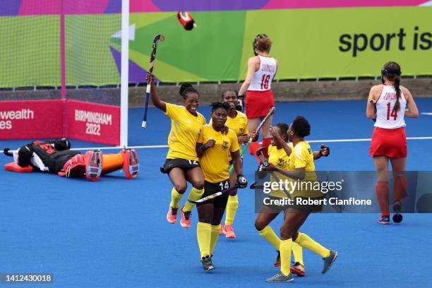 Mavis Berko of Team Ghana celebrates with team mates after scoring their sides first goal during Women's Hockey - Pool A match between Ghana and...