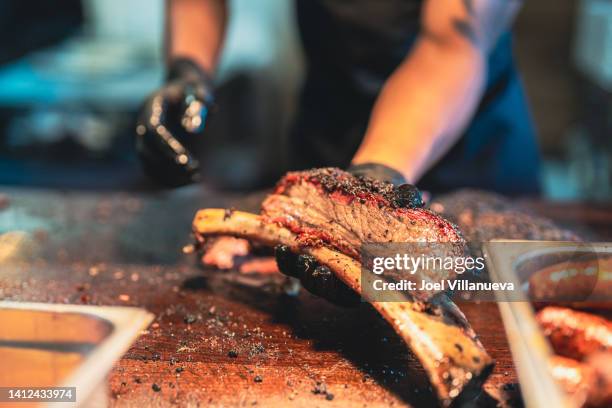 bbq chef displays a delicious  smoked brisket that's falling right off the bone. - brisket stock pictures, royalty-free photos & images