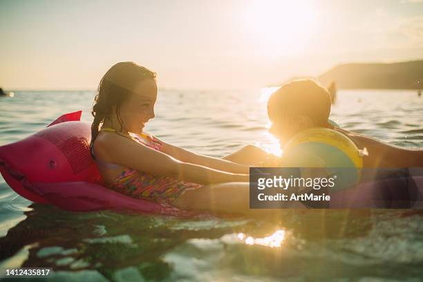 Children having fun in the sea on summer vacations