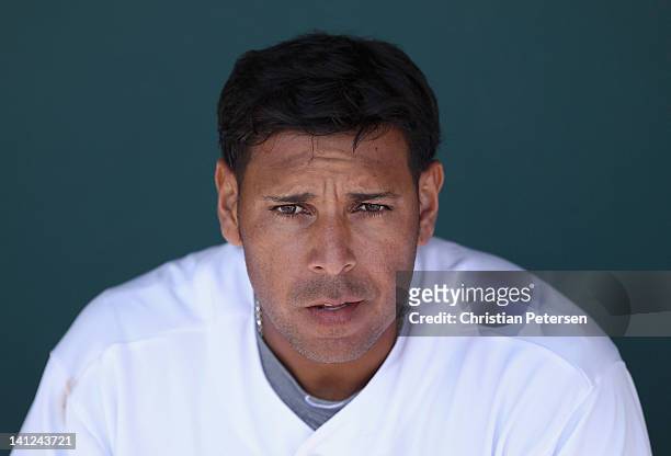 Juan Rivera of the Los Angeles Dodgers sits in the dugout during the spring training game against the Oakland Athletics at Camelback Ranch on March...