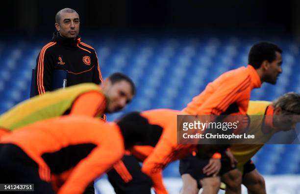 Roberto Di Matteo, interim first team coach watches over his players during a training session ahead of the UEFA Champions League round of sixteen,...