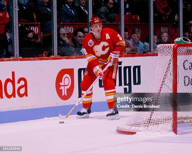 Al MacInnis of the Calgary Flames skates with the puck against the Montreal Canadiens Circa 1990 at the Montreal Forum in Montreal, Quebec, Canada.