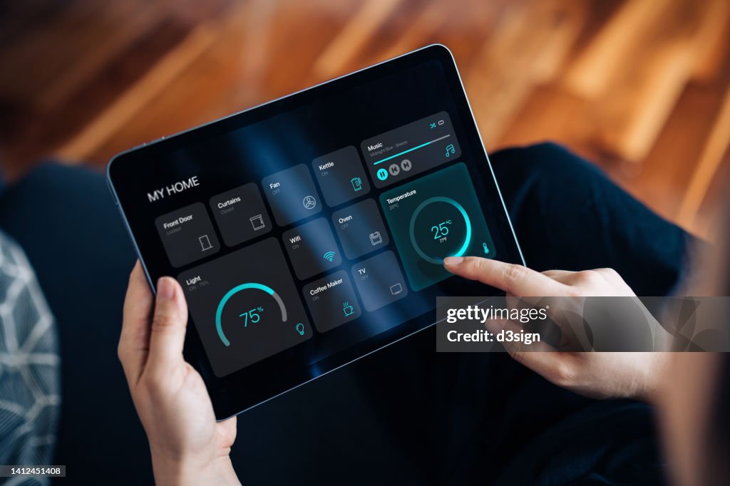 Cropped shot of young woman setting up intelligent home system, controlling smart home appliances with control panel of a smart home. Home automated system controlled from a dashboard. Smart living. Lifestyle and technology. Smart home technology concept