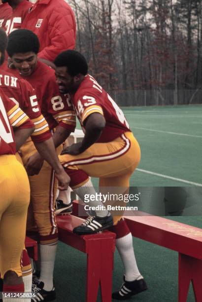 Star running back of the Washington Redskins, Larry Brown joins teammates Harold McLinton and Jimmy Jones during practice session here recently for...
