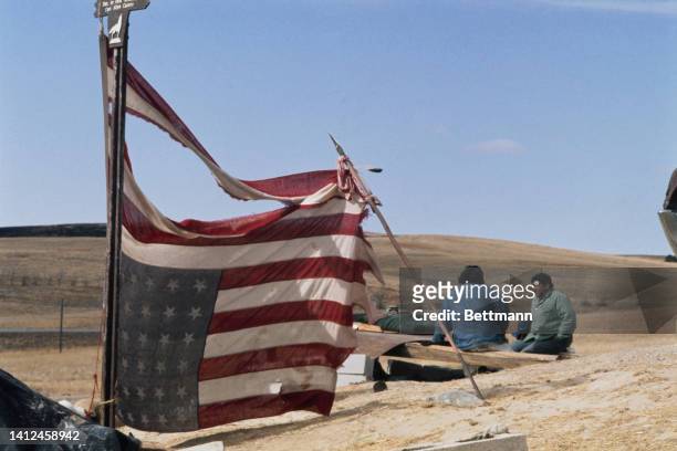 American flag, tattered and upside down, shown at the Wounded Knee, South Dakota.