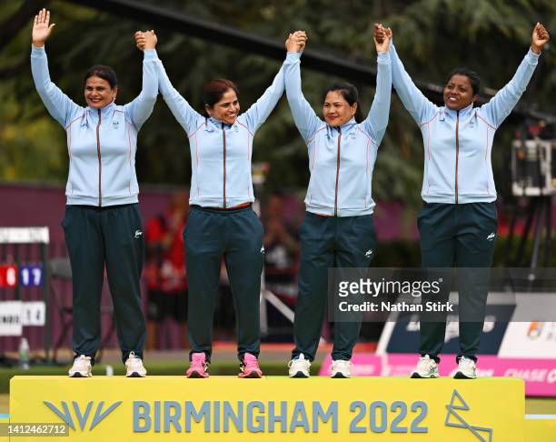 Gold medalists Lovely Choubey, Pinki, Nayanmoni Saikia and Rupa Rani Tirkey of Team India celebrate during Women's Fours - Gold Medal ceremony on day...