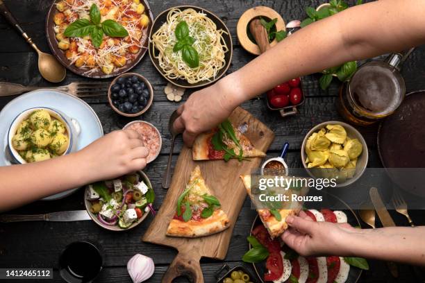 flat-lay of family dinner table with italian food - italian food and wine stock pictures, royalty-free photos & images