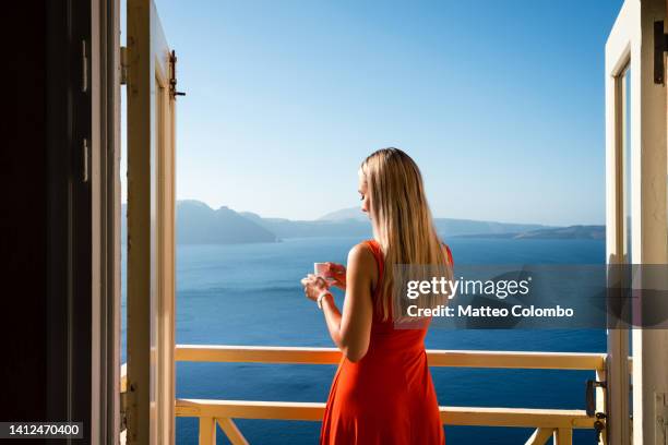 woman in red with an espresso coffee, santorini - sea cup stock pictures, royalty-free photos & images