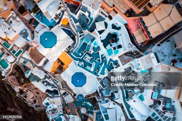overhead view of blue church and town, santorini - oia santorin stock-fotos und bilder