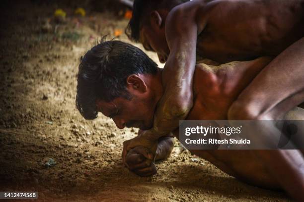 Wrestlers take part in a match at a traditional wrestling club during the Naag Panchami festival on August 02, 2022 in Allahabad, India. During the...