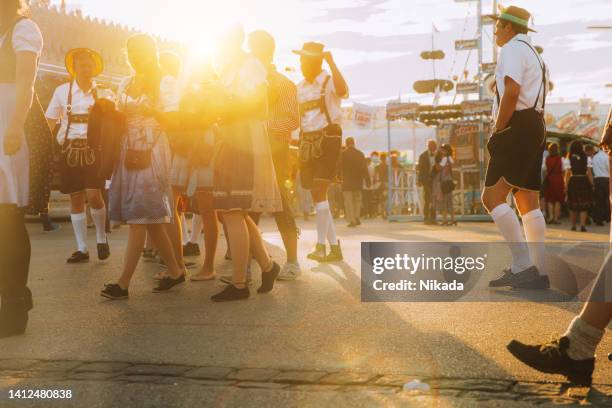 people at oktoberfest in munich, germany - theresienwiese stock pictures, royalty-free photos & images