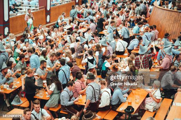 inside the loewenbrau beer tent at oktoberfest munich - oktoberfest munich stock pictures, royalty-free photos & images