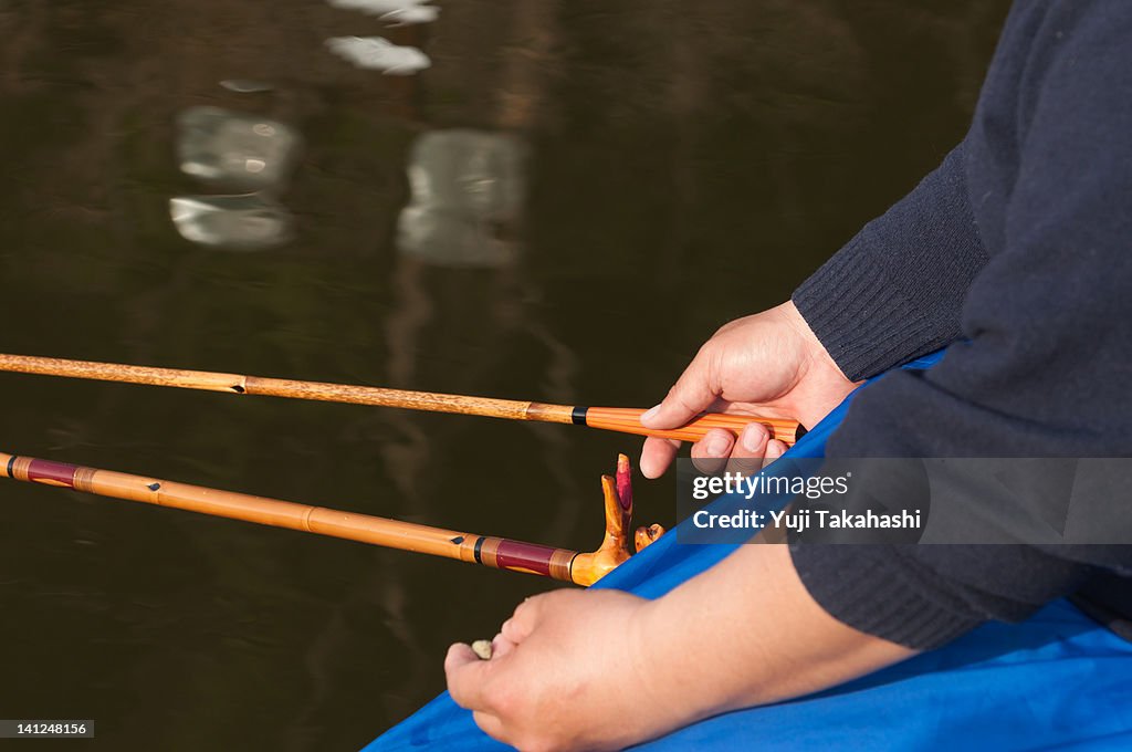 Hand grasping fishing rod