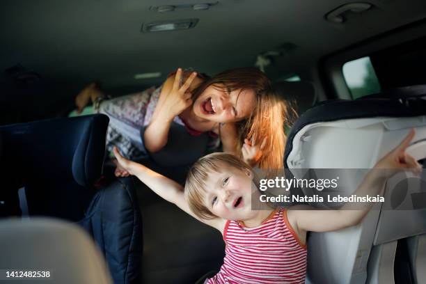 crazy funny kids sisters play in large car in summer trip - crazy car fotografías e imágenes de stock