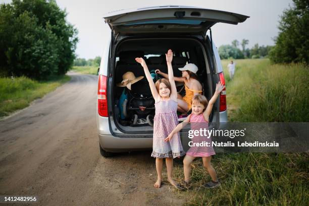 crazy funny kids sisters play in trunk large car in summer trip - road trip kids stock pictures, royalty-free photos & images