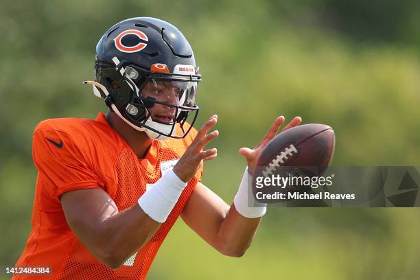 Justin Fields of the Chicago Bears takes part in a drill during training camp at the PNC Center at Halas Hall on August 02, 2022 in Lake Forest,...