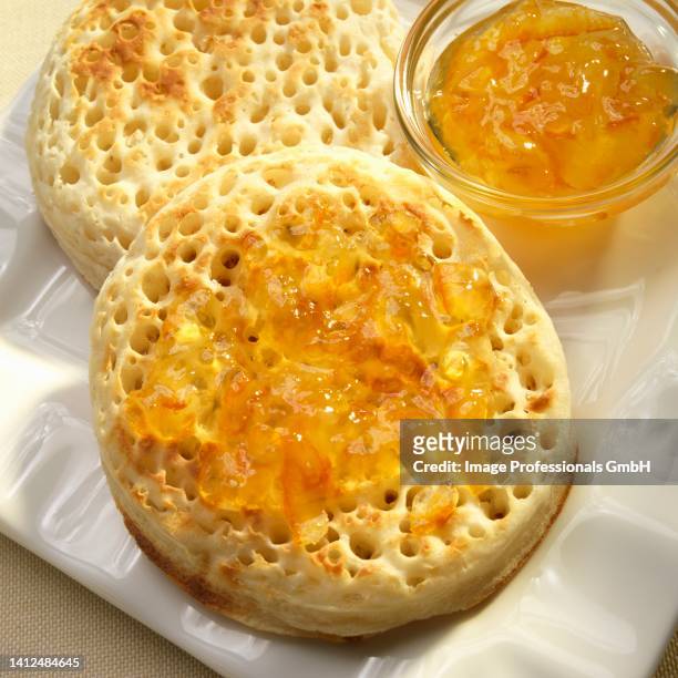a crumpet with marmalade - crumpet fotografías e imágenes de stock