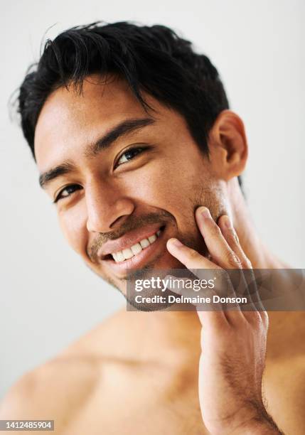 touching soft, healthy and perfect skin after grooming, skincare routine and self care while isolated on grey studio background. closeup portrait, headshot and face of satisfied, clean and fresh man - male model stock pictures, royalty-free photos & images