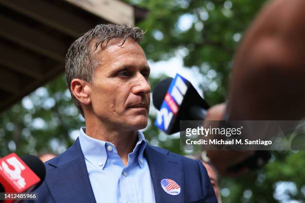 Former Missouri Gov. And Missouri Senate Candidate Eric Greitens speaks with reporters after voting during Primary Election day at the Village Hall...
