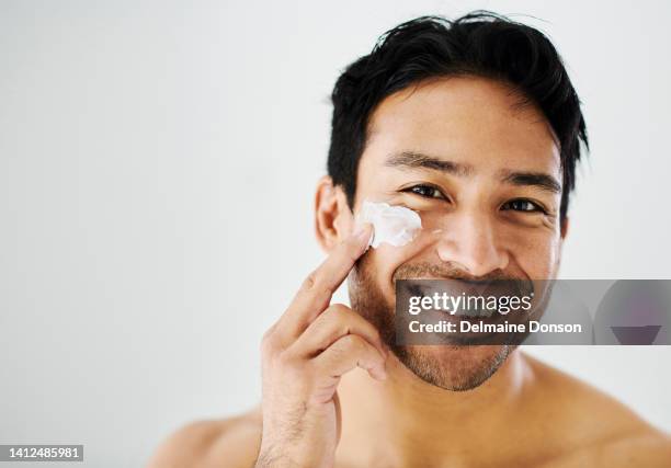 face cream and beauty of a man with healthy skin, applying moisturizer for good hygiene. routine skin care by a bare handsome male, applying lotion. a happy guy feeling fresh in the morning - men skin care stock pictures, royalty-free photos & images