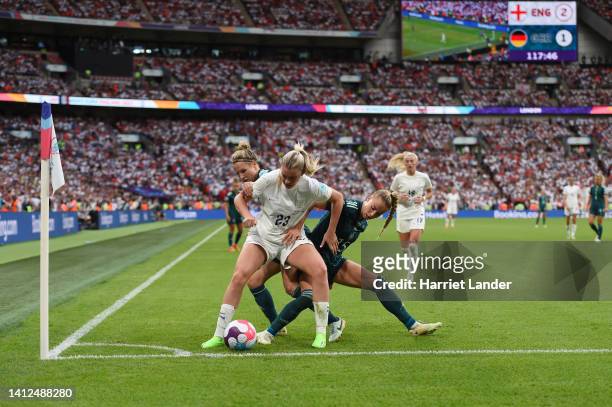 Alessia Russo of England is challenged by Svenja Huth and Giulia Gwinn of Germany during the UEFA Women's Euro 2022 final match between England and...
