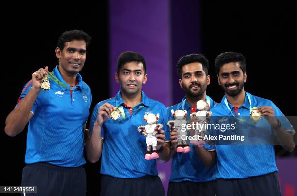 Gold Medalists team India pose on the podium during the Men's Team Event on day five of the Birmingham 2022 Commonwealth Games at NEC Arena on August...