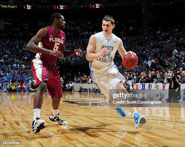 Tyler Zeller of the North Carolina Tar Heels drives against Bernard James of the Florida State Seminoles during the final game of the 2012 ACC Men's...