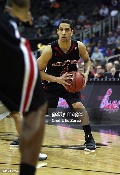 Ty Nurse of the Texas Tech Red Raiders looks to pass during a game against the Oklahoma State Cowboys in the first round of the Big 12 Basketball...