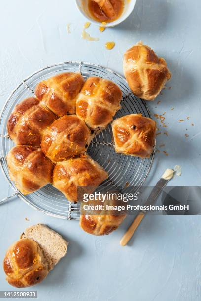 hot cross buns glazed with apricot jam and orange zest - hot cross bun stock pictures, royalty-free photos & images