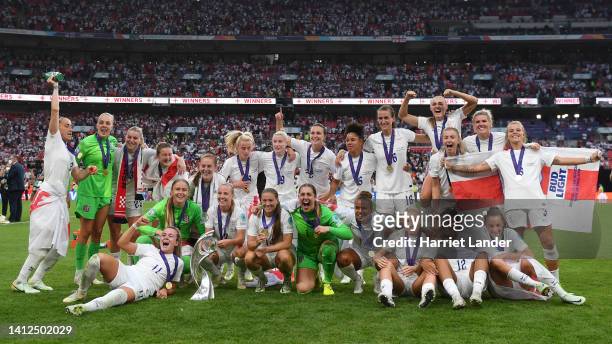The England team celebrate with the UEFA Women's EURO trophy following their team's victory in the UEFA Women's Euro 2022 final match between England...