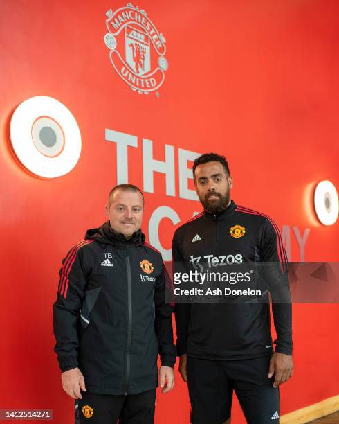 Tom Huddlestone of Manchester United poses with head of player development and coaching Travis Binnion after signing as an Academy Player/Coach at...