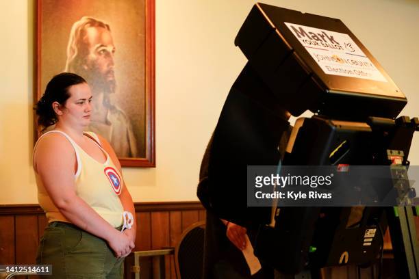 Poll worker helps a voter cast their ballot in the Kansas Primary Election at Merriam Christian Church on August 02, 2022 in Merriam, Kansas. Voters...