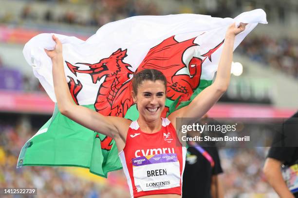 Olivia Breen of Team Wales celebrates with their countries flag after winning the Gold Medal in the Women's T37/38 100m Final on day five of the...