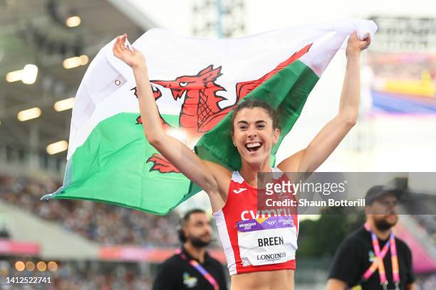 Olivia Breen of Team Wales celebrates with their countries flag after winning the Gold Medal in the Women's T37/38 100m Final on day five of the...